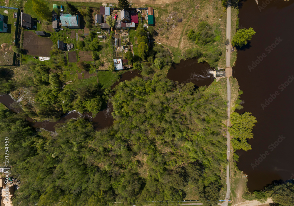 Fototapeta premium A pond in the Kamenka village, a dam and road. Sunny, summer, Aerial