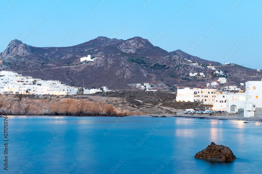 View Of town Chora in Naxos island, Cyclades, Greece. Long exposure of sea foregroung in summer time clear blue sky.