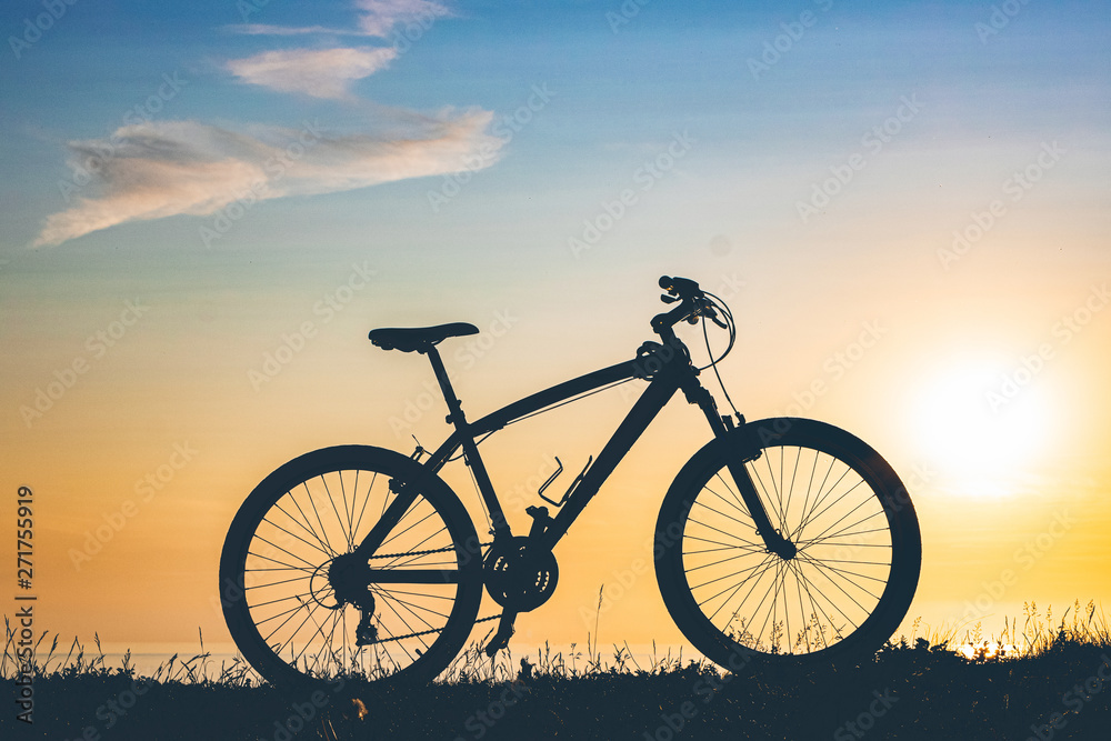 beautiful sunset on the sea and the silhouette of a bicycle