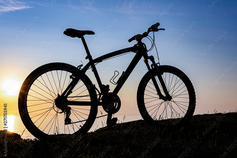 beautiful sunset on the sea and the silhouette of a bicycle