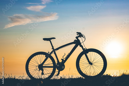beautiful sunset on the sea and the silhouette of a bicycle
