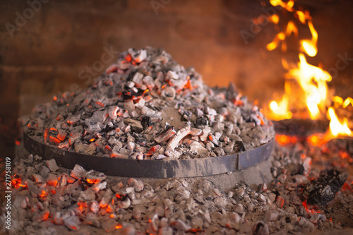 Traditional croatian dish peka in iron bell under glow photo