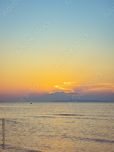 Beautiful beach sunset with blue sea and golden light sky  cloud background © jcsmilly