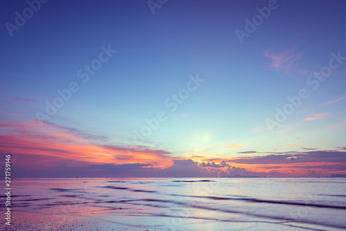 Beautiful tropical pink blue sea sunset and yellow clouds baclground