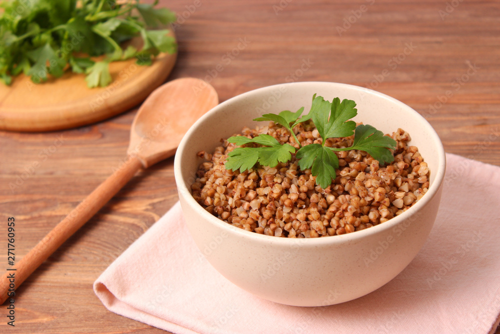 boiled buckwheat in a plate on the table. boiled buckwheat in a plate on the table.