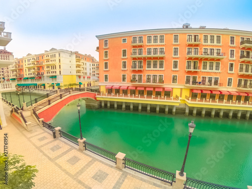 Wide angle view of panoramic bridge in Venice at Qanat Quartier in the Pearl, Persian Gulf, Middle East. Aerial picturesque district icon of Doha, Qatar in venetian style. Famous tourist attraction.