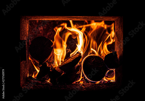 Fire in the sauna, with flames dancing in the darkness. The sauna is a central to Finnish culture. 