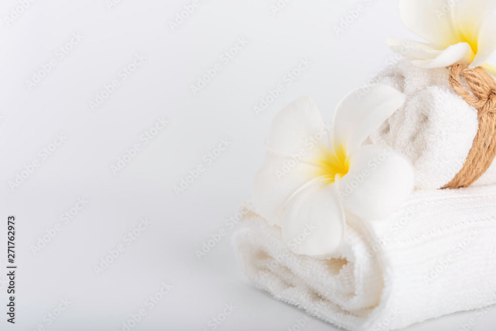 White rolled towels decorate with Frangipani flowers spa object on white background