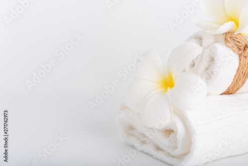 White rolled towels decorate with Frangipani flowers spa object on white background
