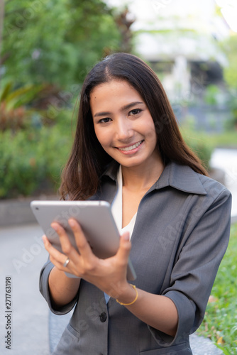 Beautiful business woman using ipad for outdoor working