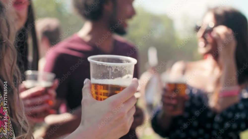 Group of people drinking beer at music festival  