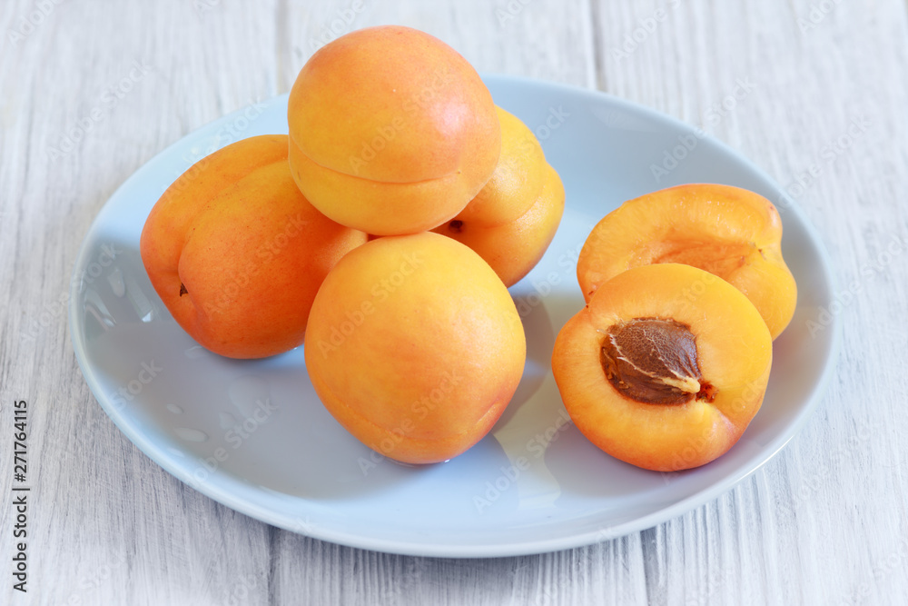 Apricots fruits on white wooden table closeup Apricots fruits on white wooden table closeup