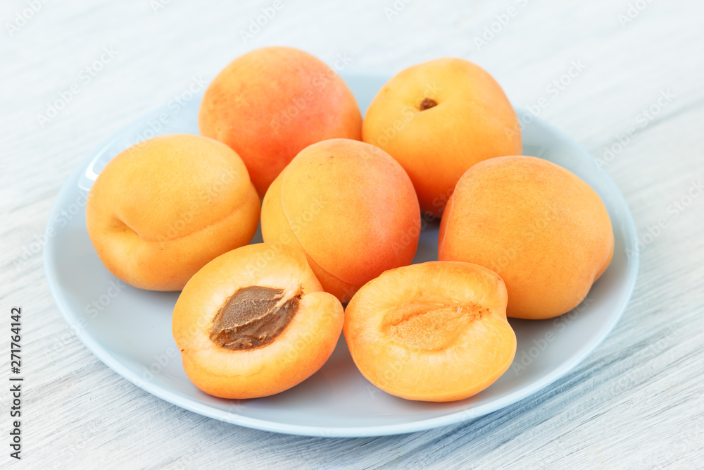 Ripe apricot fruits on table
