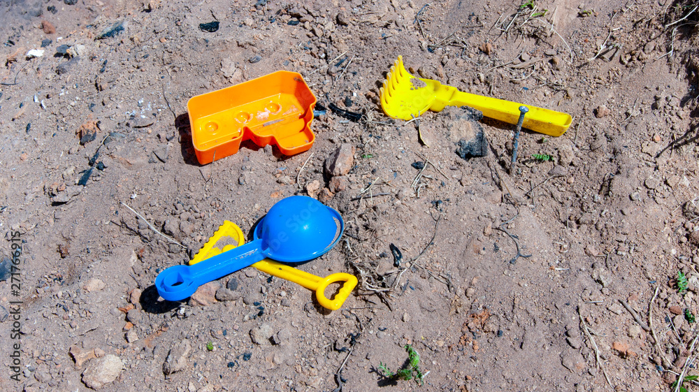 children's toys are in the dirty sand children's toys are in the dirty sand