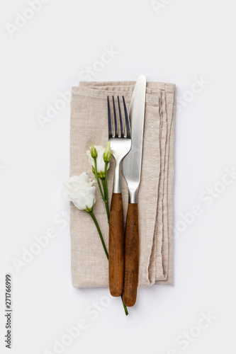 Flowers with fork and knife on white background