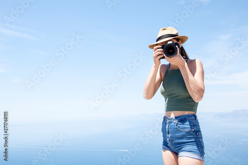 beautiful young photographer taking a photo