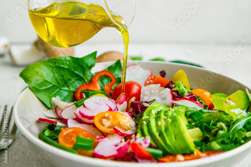 Healthy vegetables salad with oilive oil photo