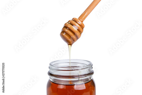 Glass jar honey and dipper high above isolated on white background