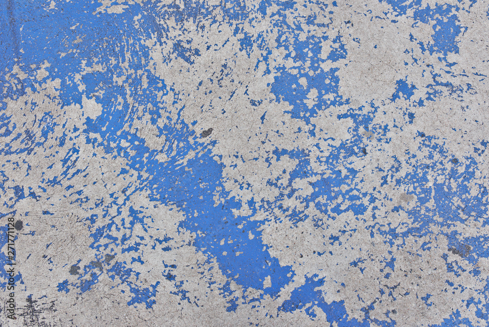 The paint on the cement floor is peeling, Blue background