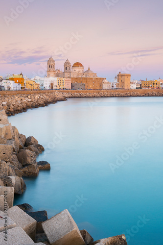 Santa Cruz Cathedral and ocean seen from the promenade along quayside, Cadiz, Andalusia, Spain photo