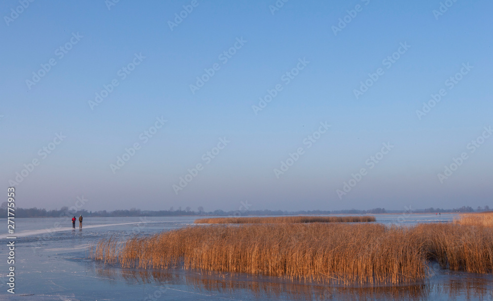 Ice skating. Winter in National park the Weerribben Overijssel Netherlands Ice skating. Winter in National park the Weerribben Overijssel Netherlands