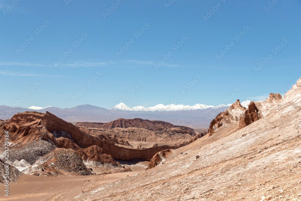Moonlike landscape of dunes, rugged mountains and geological rock formations of Valle de la Luna (Moon valley) in Atacama desert, Chile