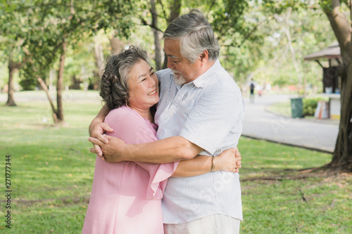 Happy elderly couple with lifestyle after retiree concept. Lovely asian seniors couple embracing together in the park in the morning. © Pormezz