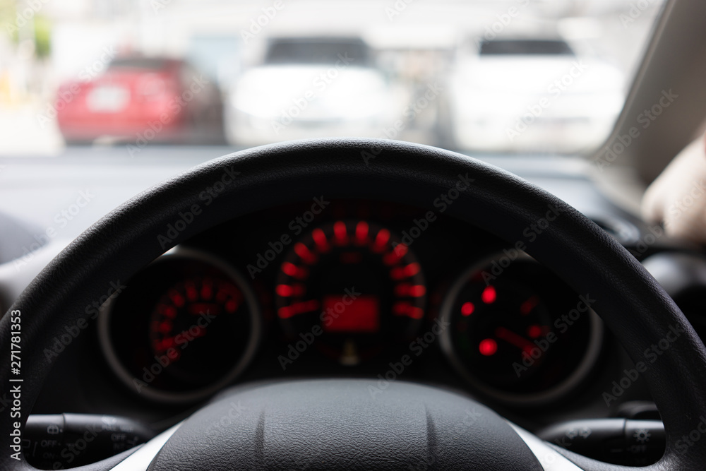Blurred background with Modern Car dashboard modern automobile control illuminated panel.Car Driving. Vehicle Steering Wheel.