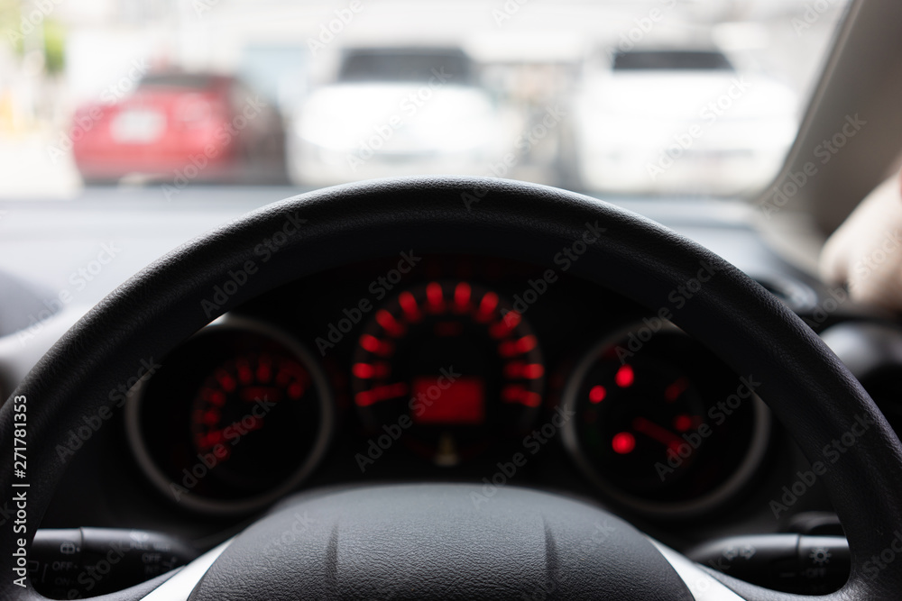 Blurred background with Modern Car dashboard modern automobile control illuminated panel.Car Driving. Vehicle Steering Wheel. Blurred background with Modern Car dashboard modern automobile control illuminated panel.Car Driving. Vehicle Steering Wheel.