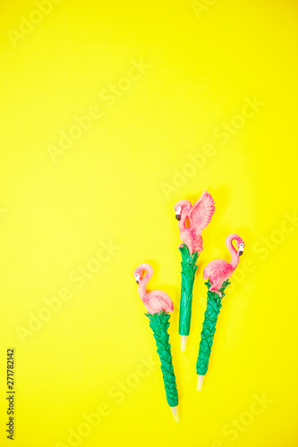 flamingo on vibrant yellow background top view