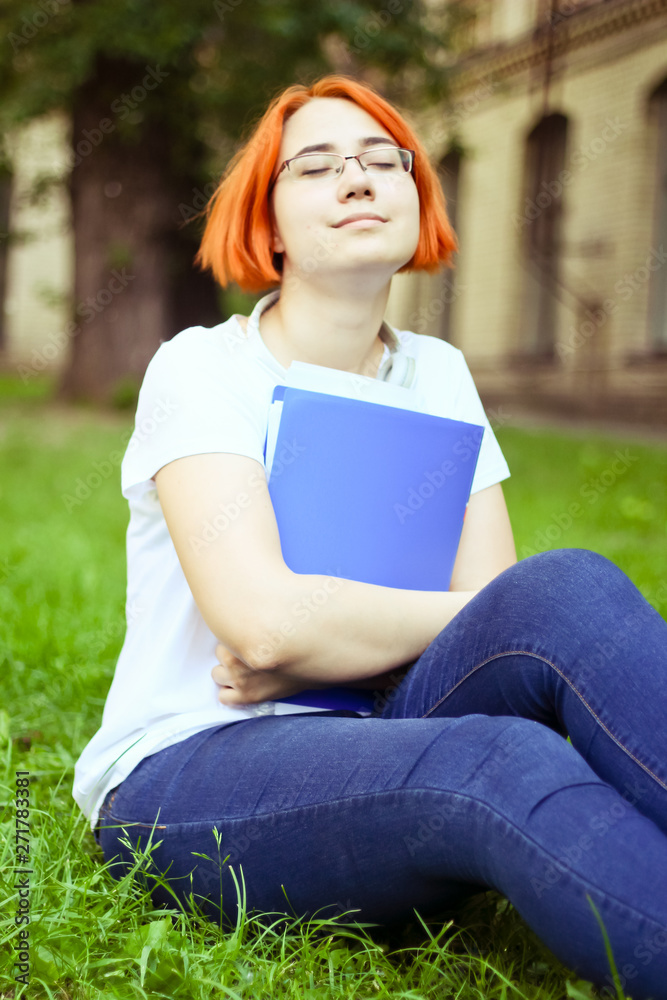 Obraz premium tired, tortured student doing homework near the university