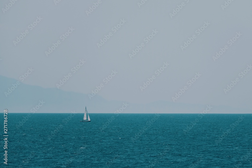 Sailboat in the blue sea in summer