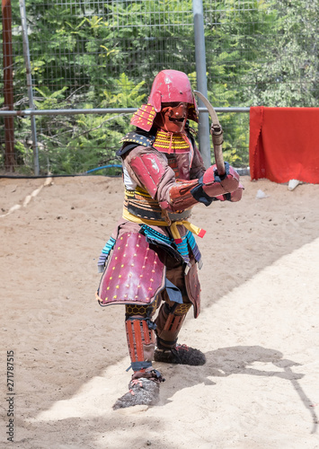 A festival participant in traditional samurai armor shows the art of naginata at the annual festival "Jerusalem Knights"