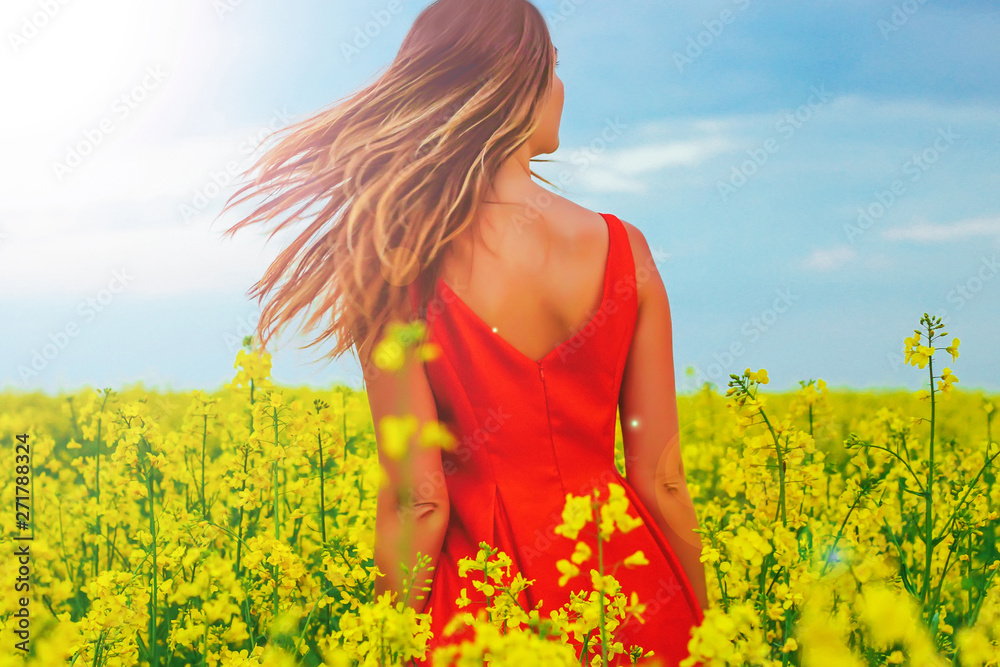 Young beautiful girl in a red dress close up in the middle of yellow field with radish flowers and highlights Young beautiful girl in a red dress close up in the middle of yellow field with radish flowers and highlights