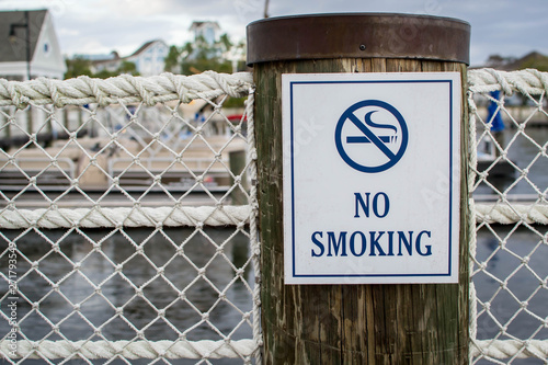 No smoking sign on wooden post photo