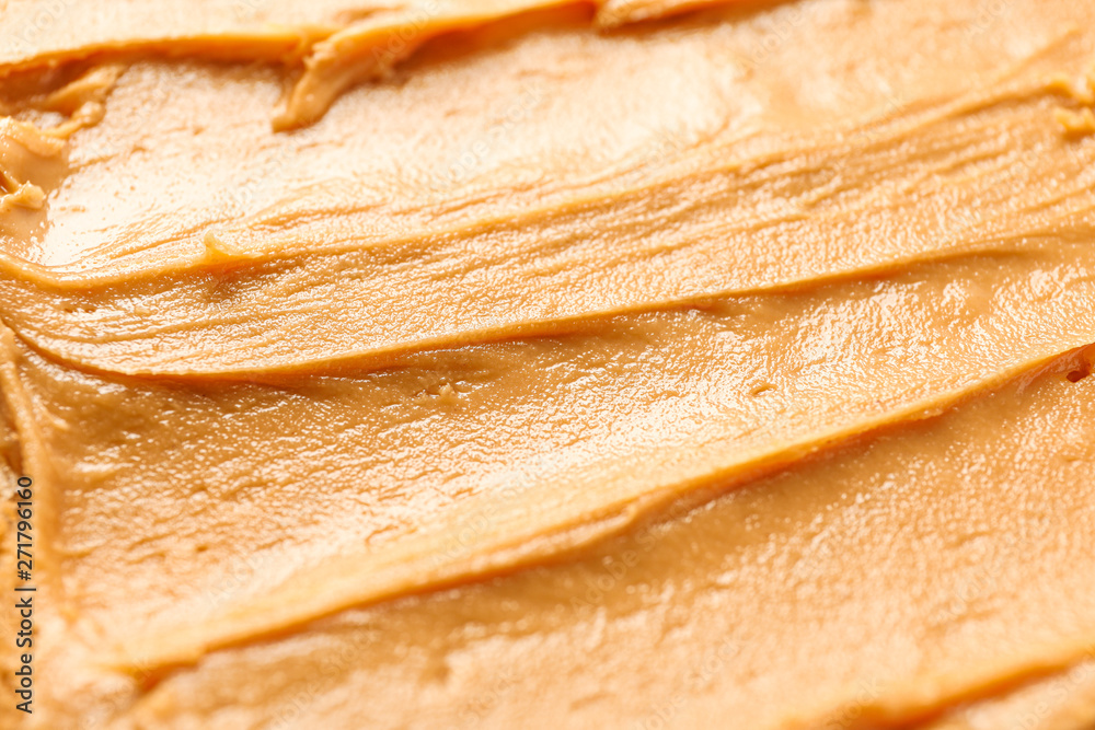 Peanut butter as background, space for text and closeup. A traditional product of American cuisine Peanut butter as background, space for text and closeup. A traditional product of American cuisine