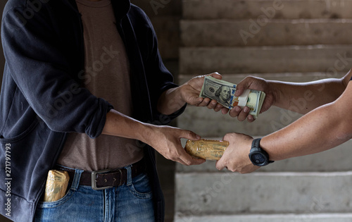 Drug addict buying narcotics and paying, Purchase, possession and sale of drugs is punishable by law.