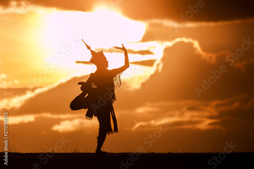 silhouette thai women dance with beautiful sunset and manora thailand