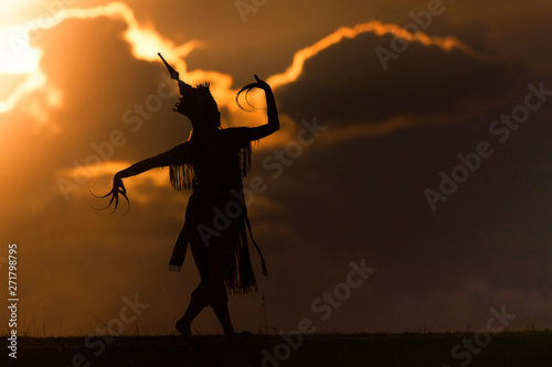 silhouette thai women dance with beautiful sunset and manora thailand