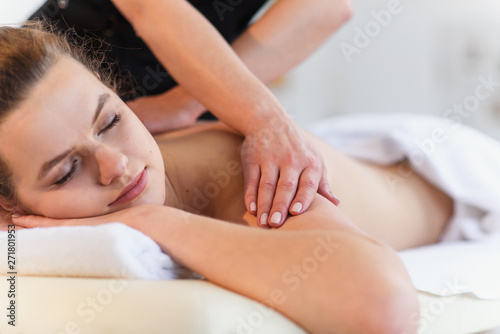 Beautiful caucasian woman enjoying treatment procedure at spa salon.