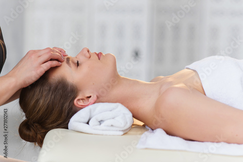 Relaxing caucasian woman during massage in the spa salon.