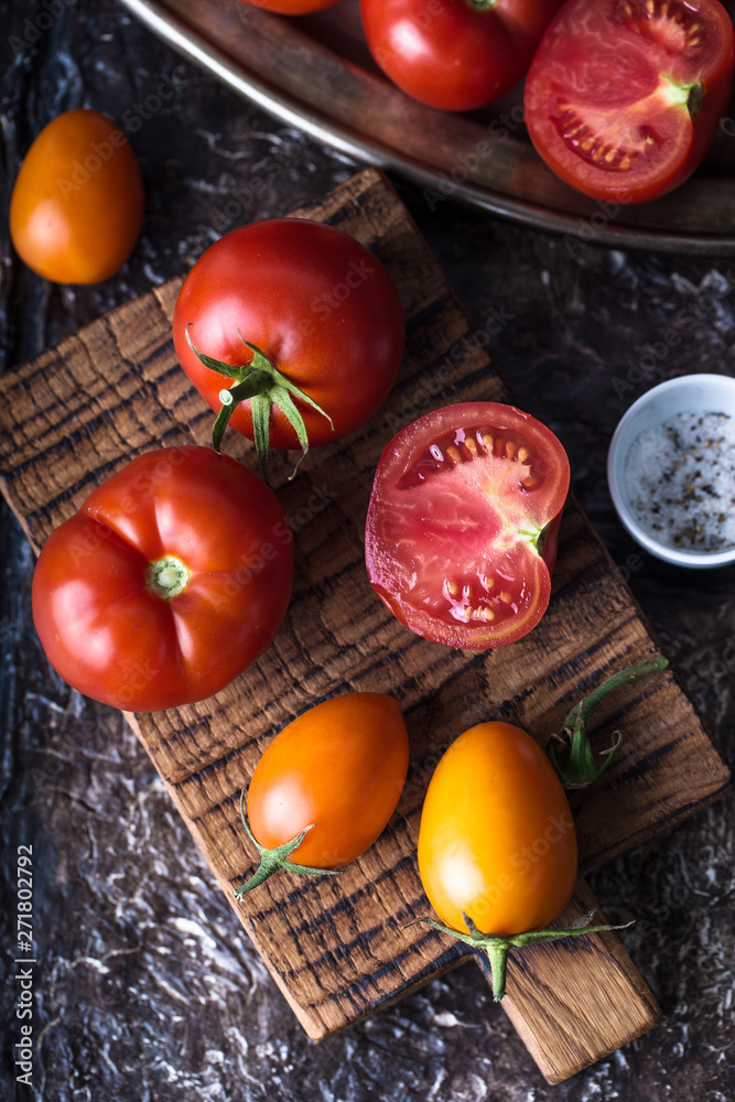 Still life of ripe tomatoes on wooden board Still life of ripe tomatoes on wooden board