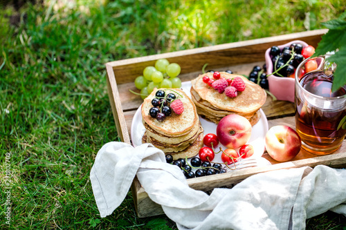 Fototapeta Naklejka Na Ścianę i Meble -  breakfast with pancake, berries and tea