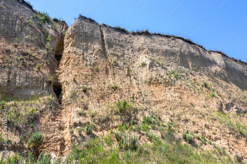 Landslide zone on Black Sea coast. Rock of sea rock shell. Zone of natural disasters during rainy season. Large masses of earth slip along slope of hill, destroy houses. Landslide - threat to life Landslide zone on Black Sea coast. Rock of sea rock shell. Zone of natural disasters during rainy season. Large masses of earth slip along slope of hill, destroy houses. Landslide - threat to life