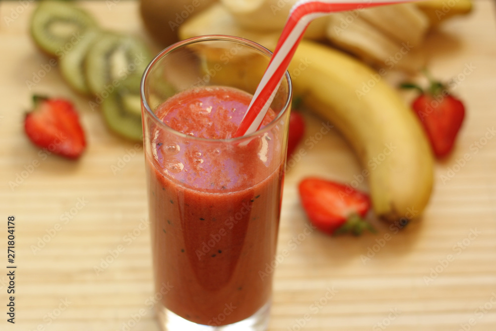 Fresh strawberry-banana smoothie with the addition of kiwi in a glass Fresh strawberry-banana smoothie with the addition of kiwi in a glass