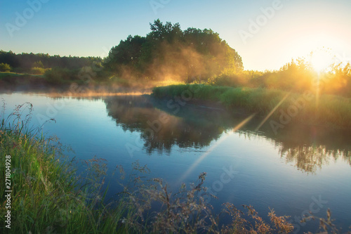 Summer river. Morning nature landscape with bright sun. Scenery sunrise over river. Beautiful calm nature background.