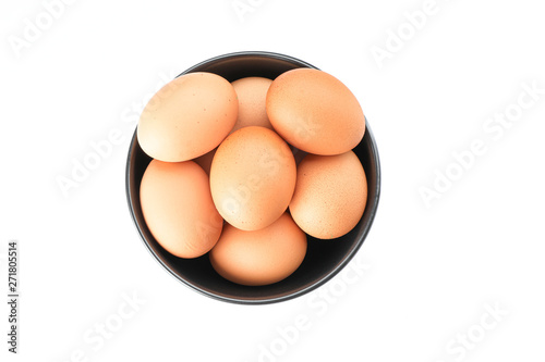 Brown chicken eggs in bowl isolated on white background, top view