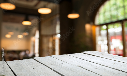 blurred background of bar and dark brown desk space of retro wood © kishivan