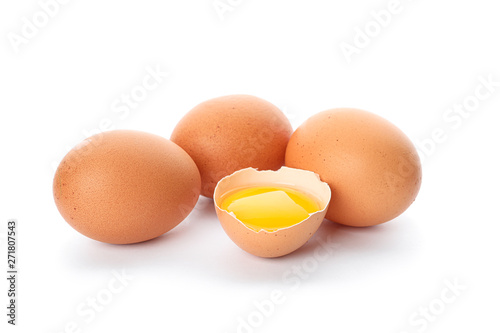 Chicken eggs and half broken egg with yolk  isolated on white background