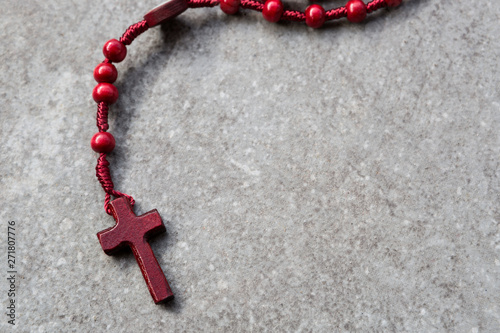 Red rosary on a stone background photo